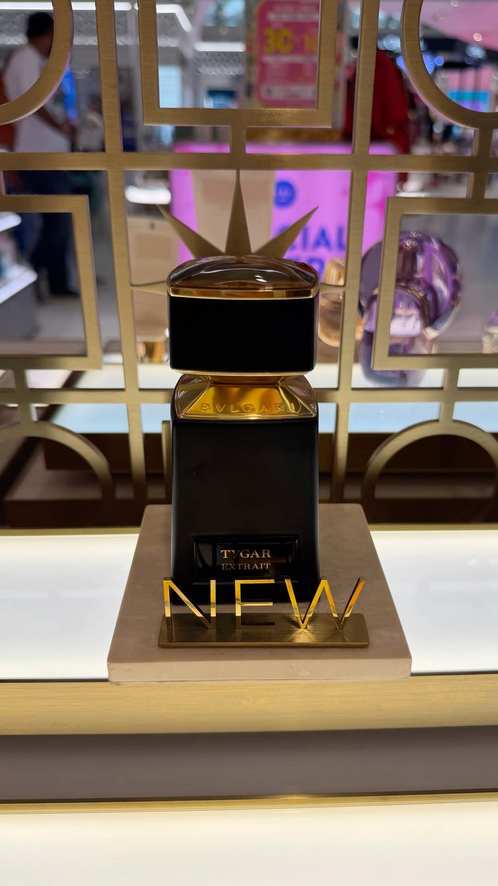 Bvlgari Tygar perfume bottle with a sleek design, displayed on a reflective surface with a dark background.