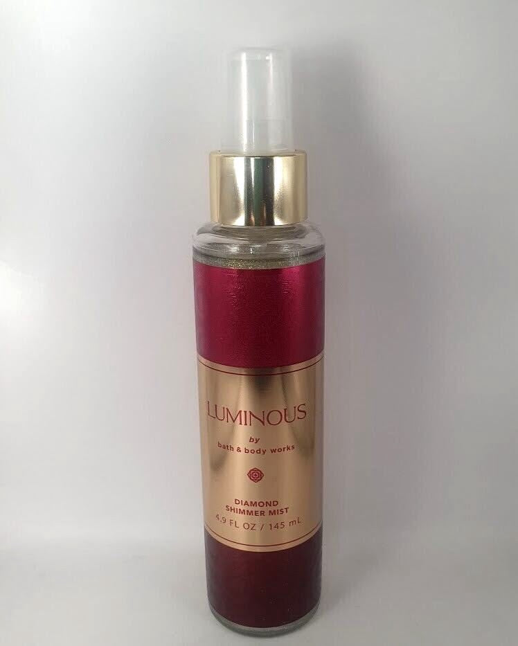 eliteessence Luminous Diamond Shimmer Mist in a sleek bottle with deep red and gold metallic accents