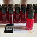 eliteessence premium red concentrated fragrance oil bottles with black caps and Greek key patterns on a business card